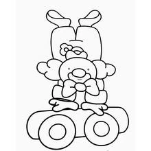 Coloriage Acrobate clown en équilibre à l'envers sur un chariot