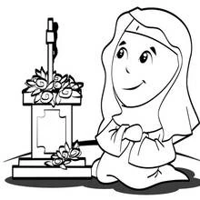 Coloriage Religieuse priant devant une tombe fleurie