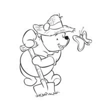 Coloriage Winnie l'ourson jardinant avec un papillon