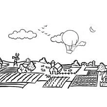 Coloriage Montgolfière survolant un paysage de village